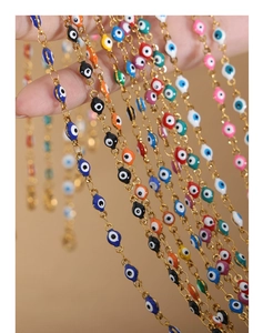 Close-up of colorful evil eye pendants on gold-plated titanium steel chain necklaces
