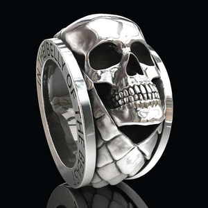 Macro view of punk silver skull ring with IN THE BELLY OF THE BEAST engraving