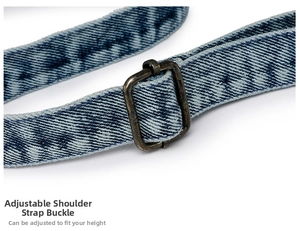 Detail of adjustable denim shoulder strap with vintage bronze metal buckle for handbag