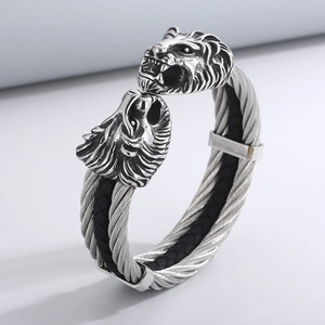 Detailed close-up of a men's stainless steel cable cuff bracelet with double lion heads