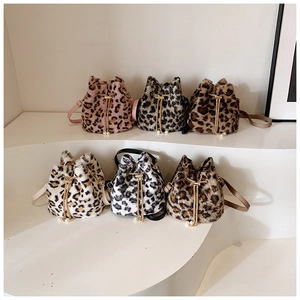 Close-up of leopard print plush bucket bags in multiple colors with pearl drawstrings