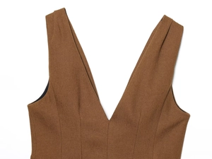 Detailed view of deep V-neckline on brown linen-blend vest with textured fabric