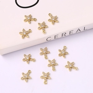 Macro shot of 10 golden starfish charms with cubic zirconia for DIY jewelry making
