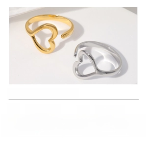 Detail of heart hollow design open rings in gold and silver finish stainless steel