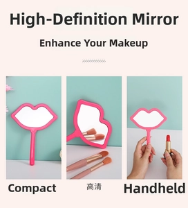 Lip-shaped handheld makeup mirror with ergonomic pink handle for portable touch-ups