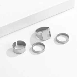 Set of 4 minimalist silver metal rings including wide signet and open band styles