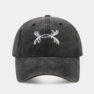 Close-up of white antler embroidery on vintage washed charcoal cotton baseball cap