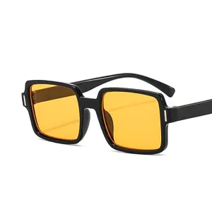 Retro square sunglasses with thick black frame, yellow lenses, and metal nail accents