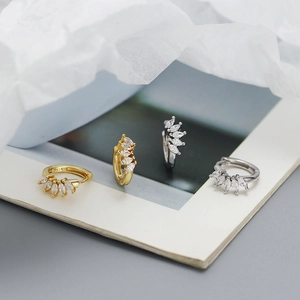 Detailed macro view of S925 silver hoop earrings with marquise-cut zircon in gold and silver