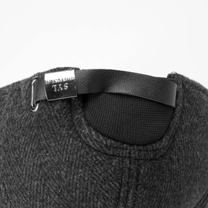 Macro detail of adjustable leather strap and metal buckle on warm winter baseball cap