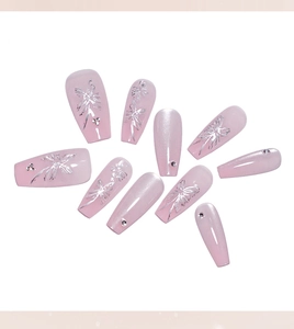 Detail of pink cat eye coffin nails with silver butterfly accents and small rhinestones