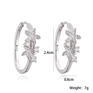 Star-shaped silver earrings set with sparkling crystals in a professional studio shot
