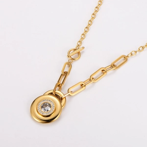 Gold OT clasp necklace with a round rhinestone pendant and halo design in studio lighting