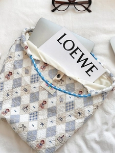 Quilted blue checkered canvas tote bag with cartoon bear pattern and woven handles