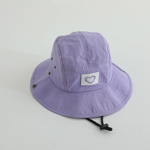 Close-up of purple quick-dry bucket hat featuring a heart patch and adjustable chin strap