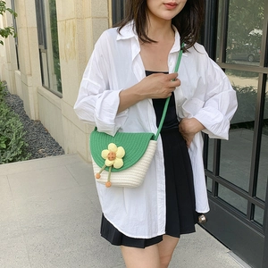 Straw flower woven bucket bag for women with green flap and floral accent for summer beach