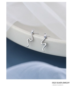 Macro shot of S925 sterling silver snake stud earring with cubic zirconia accents