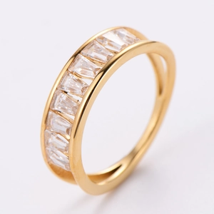 Close-up of golden ring featuring rectangular clear cubic zirconia in a prong setting