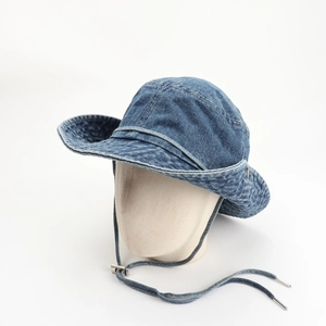 Detail view of washed denim sun hat featuring an adjustable chin strap and metal buckle