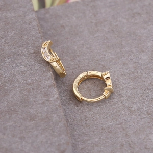 Close-up of 18K gold crescent moon hoop earrings with micro-inlaid sparkling zircon stones