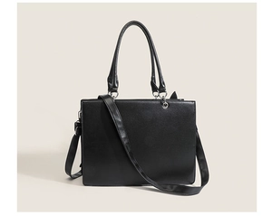 Detail of a black gothic tote bag with silver hardware and detachable strap for styling