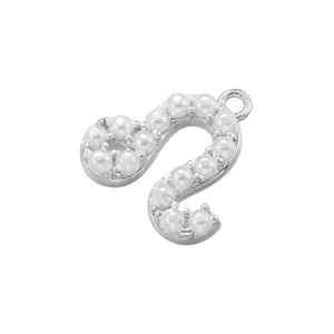 Detailed close-up of S-letter charm pendant with small white pearls and silver metal base