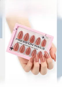 Detail of glossy almond press-on nails in dusty rose finish in a compact box