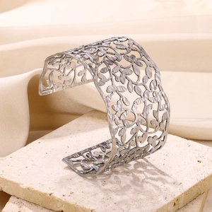 Wide open stainless steel cuff bracelet with hollow leaf pattern and hammered texture