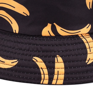 Detail of reinforced stitching on black bucket hat with yellow banana pattern print