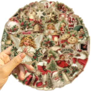 Close-up of vintage Christmas stickers featuring Santa and angels for DIY decoration