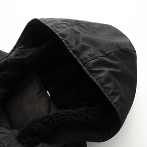 Close-up of black windproof fabric and thick fleece lining on the hooded bomber jacket