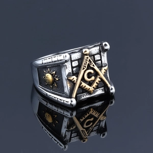 Macro shot of two-tone Masonic square and compass ring with sunburst pattern details