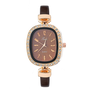 Detail of rose gold crystal bezel and brown wood grain dial on women's quartz watch