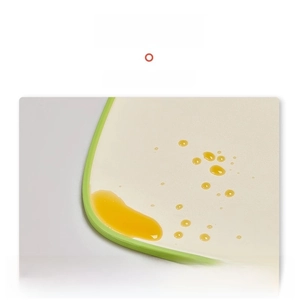 Detail of cutting board with raised green edges to prevent fruit juice from overflowing