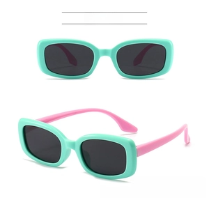 Detail view of stylish kids sunglasses with mint green frames and pink silicone temples