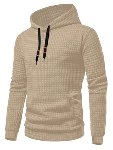 Detail of men's beige waffle knit hoodie featuring textured fabric and black drawstrings