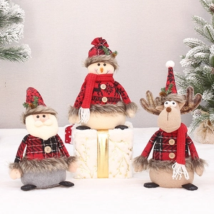 Three Christmas plush dolls featuring Santa, Snowman, and Reindeer in red knit outfits