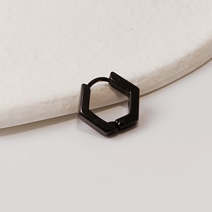 Macro detail of a hexagonal black stainless steel hoop earring with a polished finish
