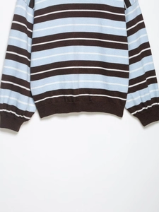 Detailed view of the mint and brown striped knit sweater with ribbed cuffs and hem