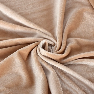 Macro shot of champagne velvet fabric showing fine texture and metallic sheen of the set