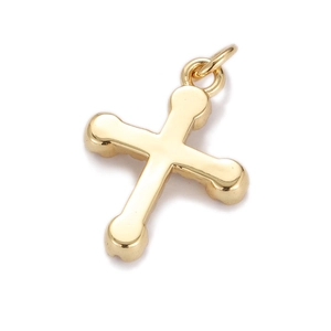 Macro close-up of the polished gold-plated cross pendant with metallic gloss