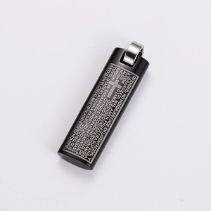 Macro shot of black stainless steel rectangular pendant with engraved Spanish Lord's Prayer