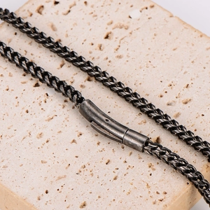 Vintage stainless steel black keel chain necklace for men on stone background