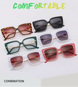 Matrix display of oversized butterfly sunglasses in six colors with gold metal accents