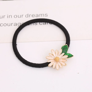 Elegant white pear flower hair tie with yellow core and green leaves on black elastic band