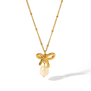 Detail of 18K gold bow necklace featuring a white pearl drop on white background