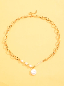 Detail view of a gold chain necklace featuring white faux pearls and a round pearl pendant
