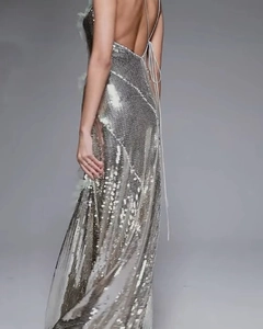 Detailed view of silver sequin evening dress featuring backless design and halter neck