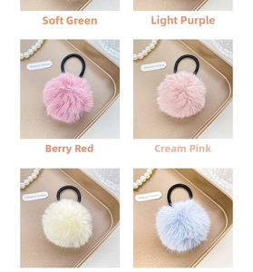 Detailed close-up of fluffy macaron plush pom pom hair ties on elegant metal tray