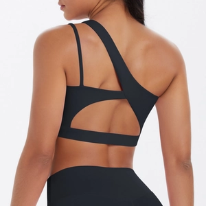 Detail view of black sports bra featuring asymmetrical straps and geometric back cutout